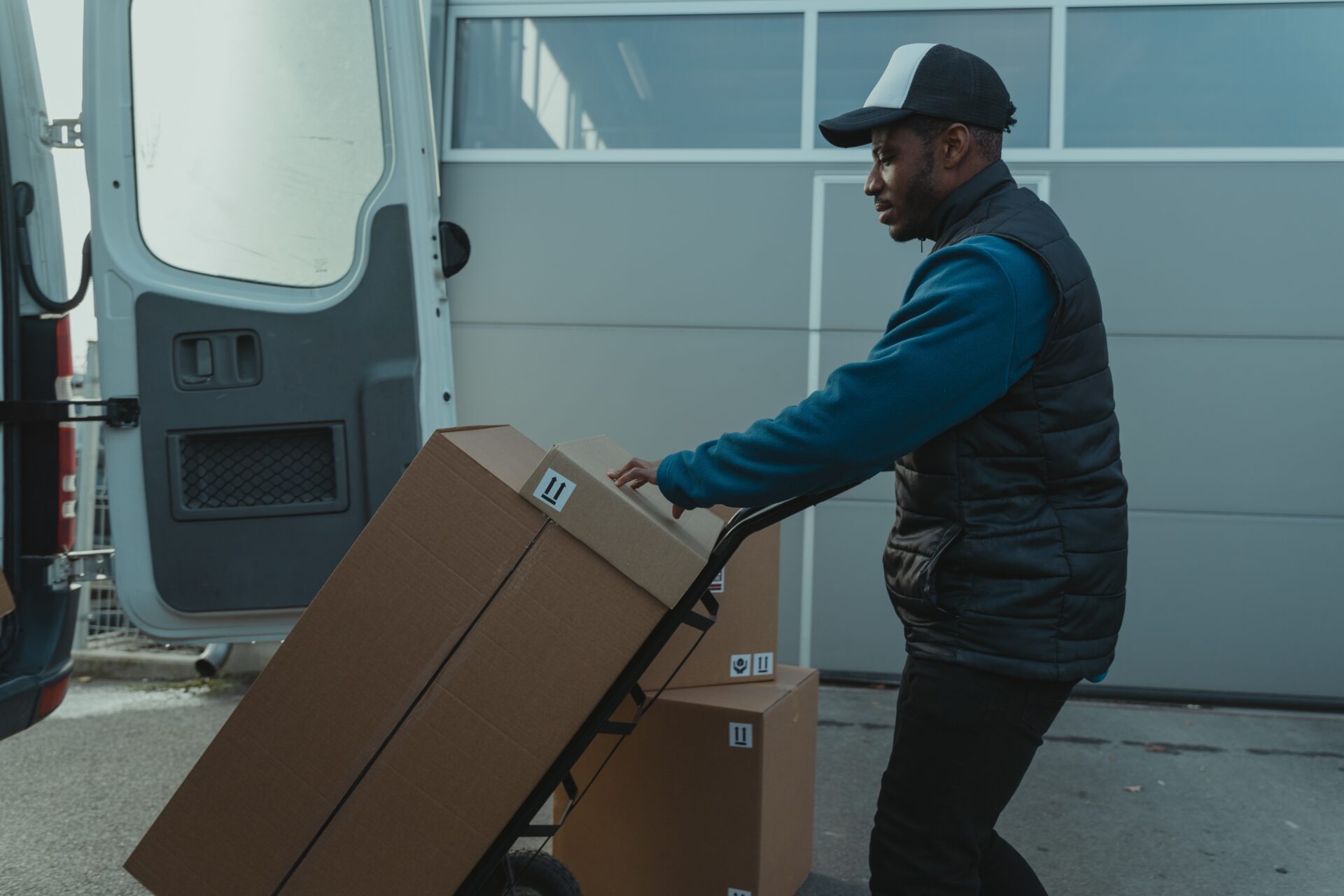 deliver person hauling large box in moving van